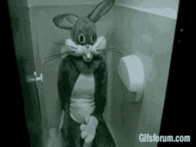 a person in a bunny costume is sitting on a toilet