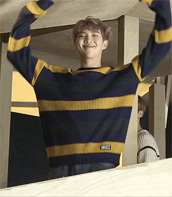 a young man wearing a striped sweater with the word patagonia on the sleeve