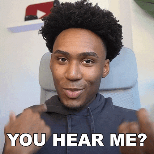 a man in a black hoodie is pointing at the camera with the words you hear me behind him