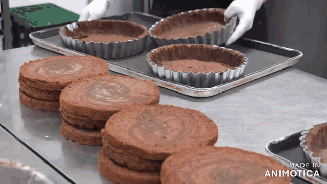 a bunch of chocolate cakes are on a tray with the words made in animatica on the bottom