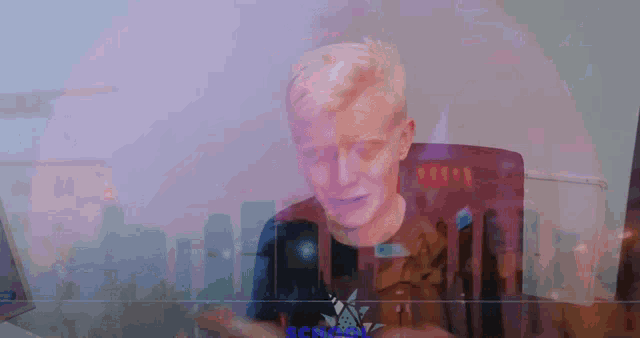 a man is sitting in front of a computer screen with the word school written on it