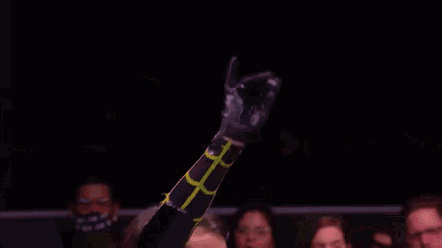 a shirtless wrestler is sticking his tongue out in front of the crowd