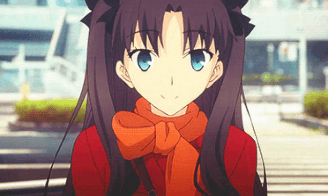 a girl with dark hair and blue eyes wearing a red jacket and orange scarf