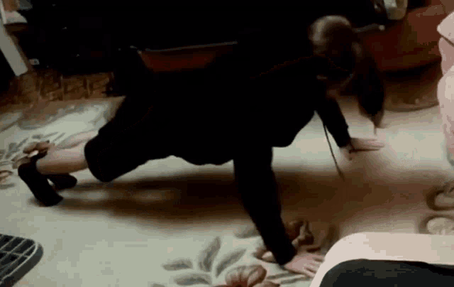 a woman is doing push ups in a living room .