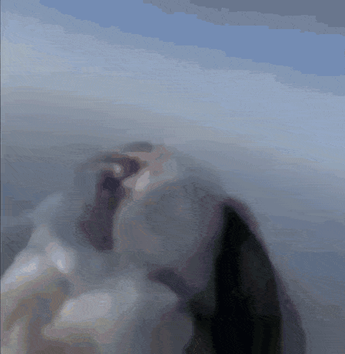 a blurred image of a person in a black jacket and tie