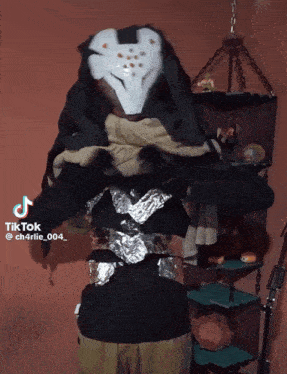 a tiktok video of a person wearing a black and white costume