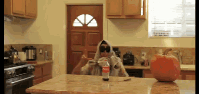 a bottle of coca cola sits on a counter in a kitchen