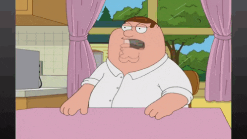 peter griffin from family guy sitting at a table