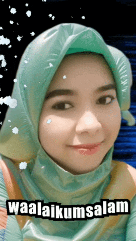 a woman wearing a green hijab with the words waalaikumsalam on the bottom