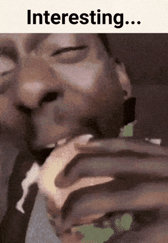 a man with his eyes closed is eating a sandwich with the word interesting below him