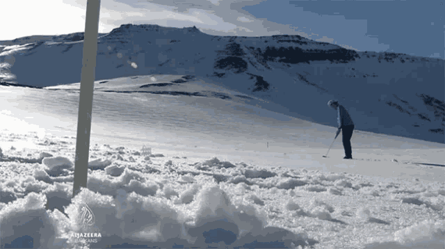 a man playing golf in the snow with a sign that says rojazebra on it