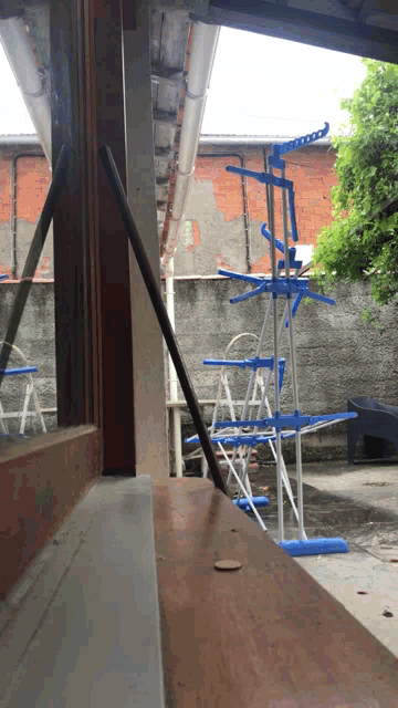 a window with a ladder in the background