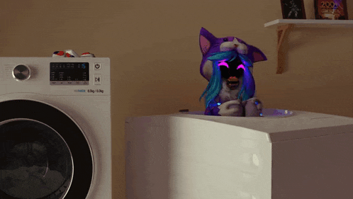 a stuffed animal is sitting in a washing machine that says samsung