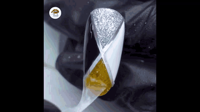 a close up of a nail being painted with a triangle design
