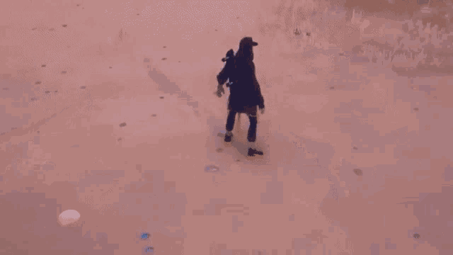 a person is laying on their back in the sand on a beach .