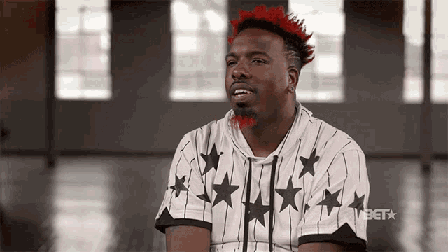 a man with red hair is wearing a shirt that says bet on the front