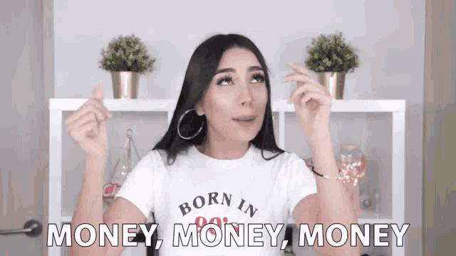 a woman wearing a white born in money shirt