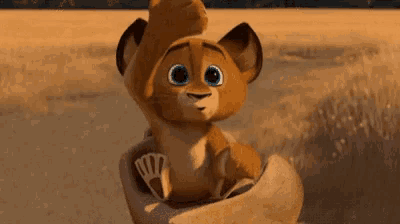 a cartoon lion cub is being held by someone