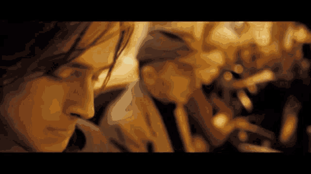 a close up of a man 's face with a blurry background of other people
