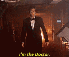 a man in a tuxedo says i 'm the doctor in a dark room