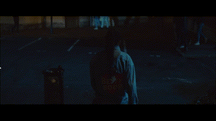 a blurry picture of a person walking down a dark street