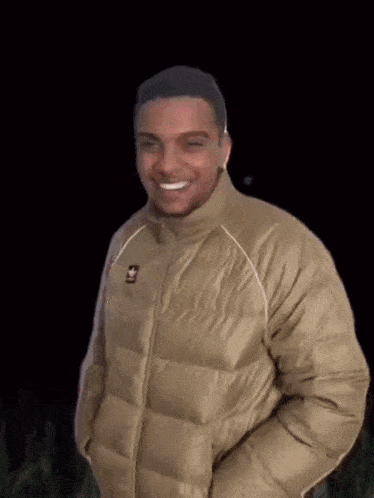 a man in a plaid jacket is talking on a cell phone .