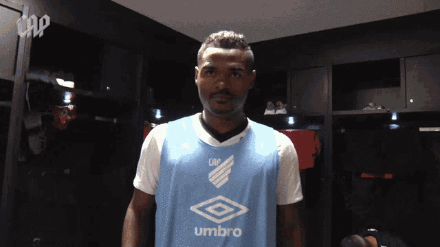 a man wearing a light blue umbro jersey