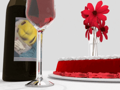 a bottle of wine sits next to a wine glass and a cake
