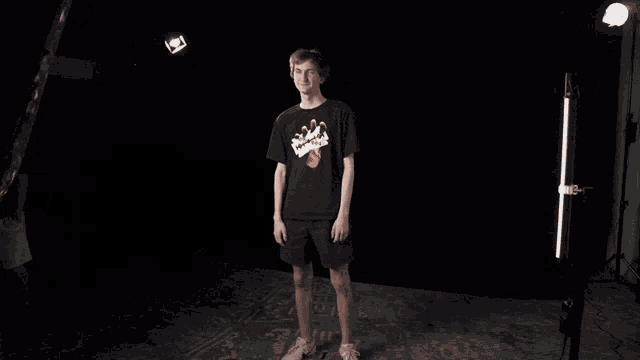 a man wearing a shirt that says mis on it scratches his head