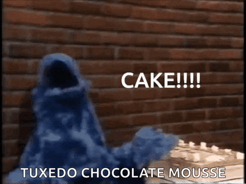 cookie monster is holding a piece of cake and says cake !!!