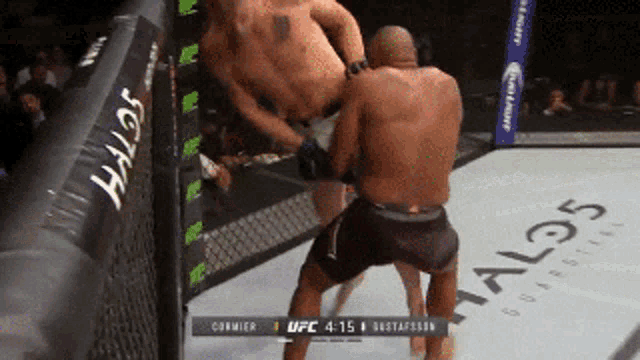 two men are fighting in a boxing ring with a halo 5 logo on the floor