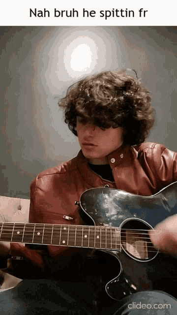 a man in a red jacket is playing a guitar with the caption nah bruh he spittin fr