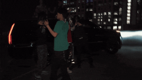 a man wearing a green shirt with a skull on it is dancing