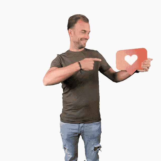 a man is pointing at a red heart shaped icon