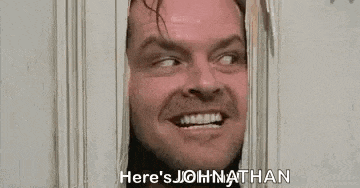 a man is looking through a hole in a door and screaming .