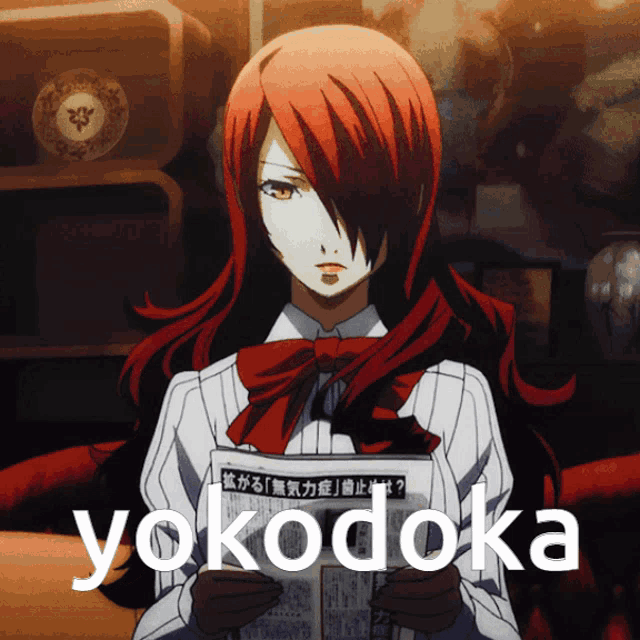 a girl with red hair is holding a piece of paper that says yokodoka on it