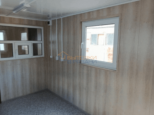 a room with wood paneling and a window with a sign that says " вытяжки " in the corner