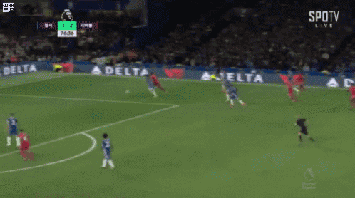 a soccer game is being played on a field with a delta ad in the background