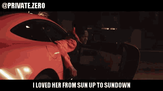 a man in a red jacket is getting out of a red car
