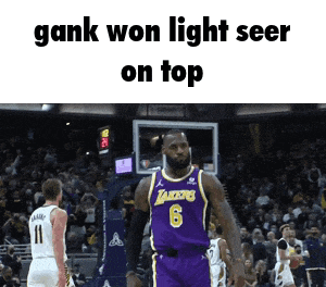 a basketball player wearing a lakers jersey stands on top of a basketball court
