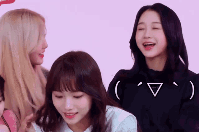 a girl with a triangle on her face is surrounded by other girls
