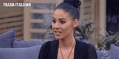 a woman is sitting on a couch with a bun in her hair .