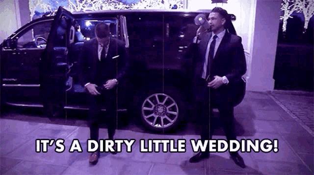 two men in suits and ties are standing in front of a car with the words it 's a dirty little wedding ..
