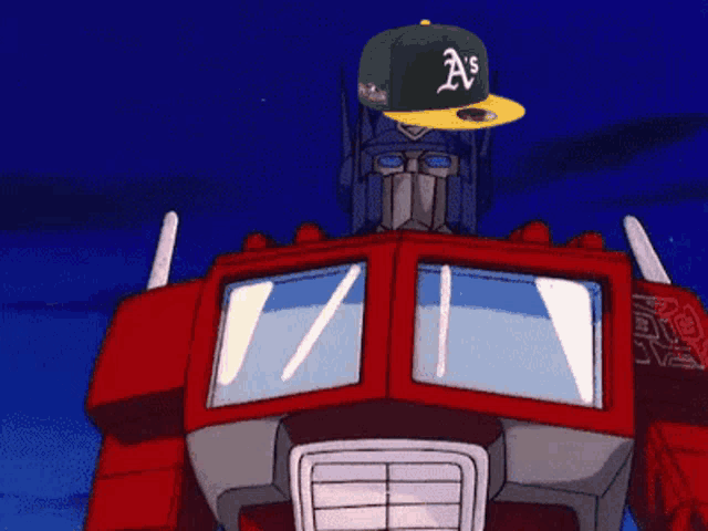 a robot wearing a green a's hat giving a thumbs up