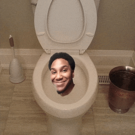 a man 's head is sticking out of a toilet seat