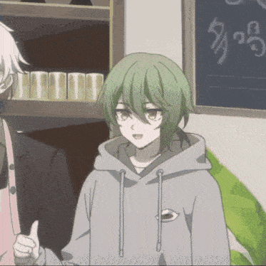 a person with green hair is wearing a grey hoodie