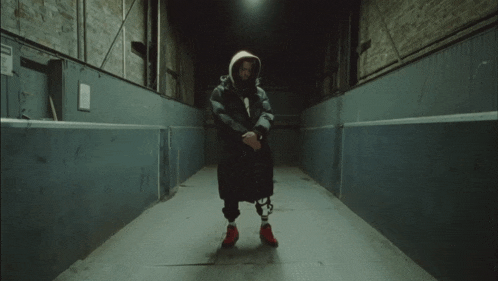 a person standing in a dark hallway with a white bag on their head