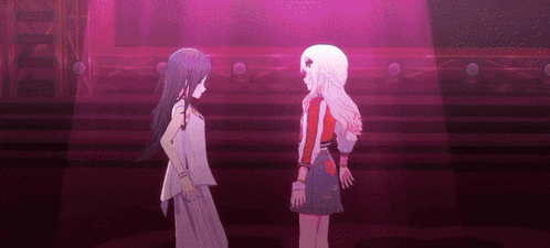 a couple of anime girls standing next to each other on a stage