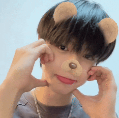 a young boy wearing a teddy bear mask makes a face