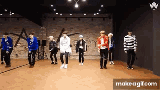 a group of young men are dancing in a dance studio
